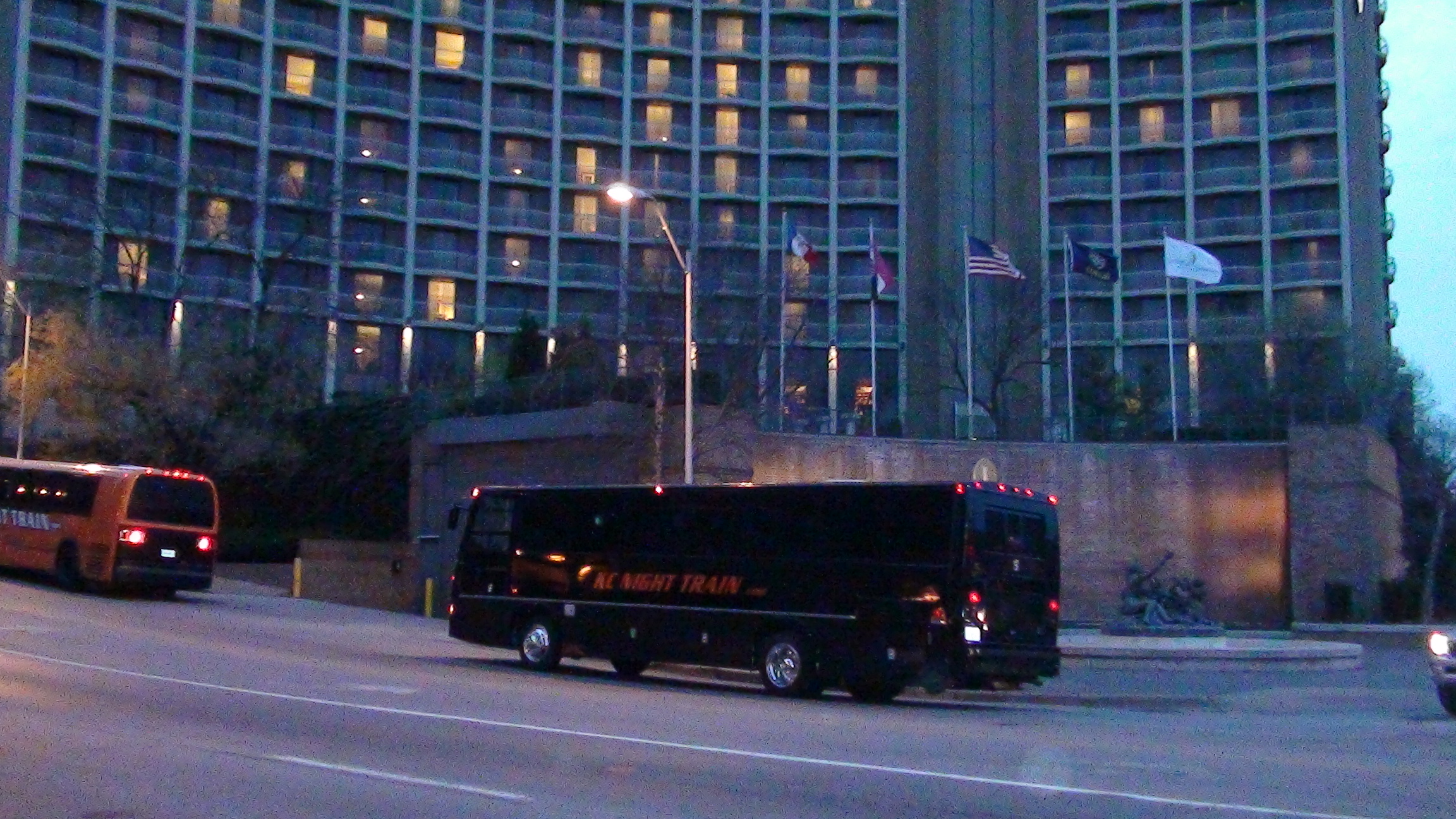 Black VIP Party Bus parked in front of hotel